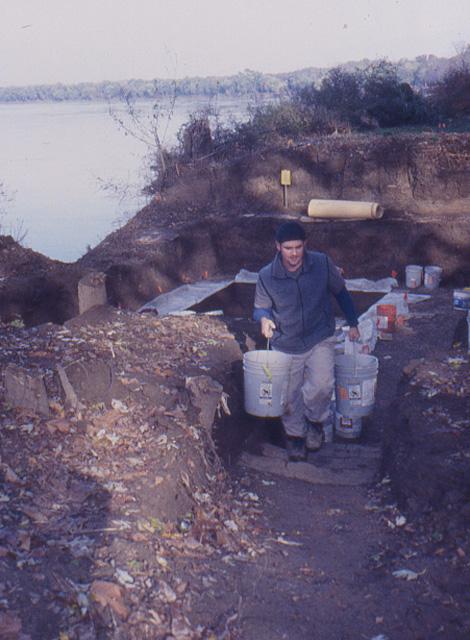 Tony D'Albini carrying buckets of excavated soil to the water screen