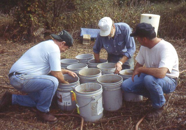 Leon Hostettler, Patrick Munson, and Frank Gerth stir the soil
