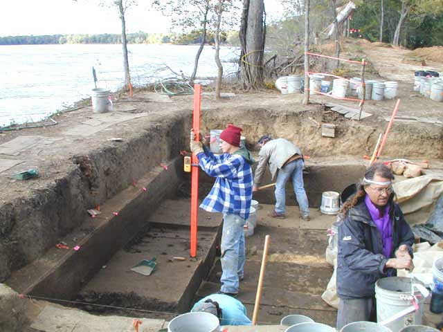 Don Bialkowski marks the target excavation depth using the laser level receiver that is on the orange rod.