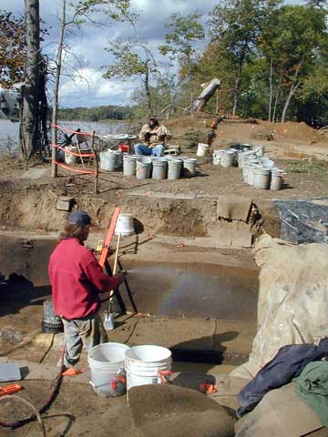 Two people with buckets at the site