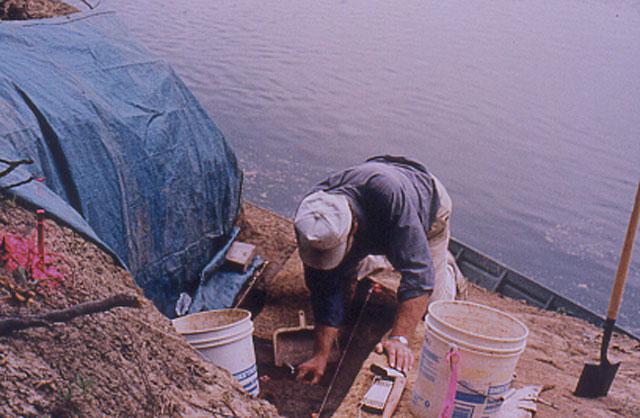 Person doing excavation on the riverbank