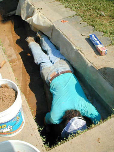 Rexford Garniewicz, excavating deep wall trench in block 8.