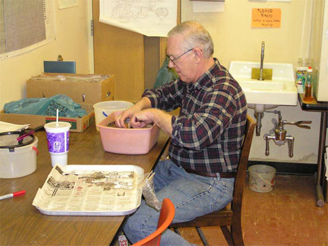 Tom Ciskowski washes artifacts to prepare them for size-grading, identification, and cataloging