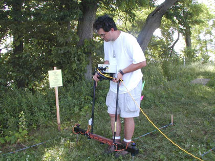 Duane Simpson of AMEC Earth & Environmental, Inc. running the resistivity equipment on a grid.