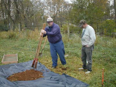 Person using a posthole digger