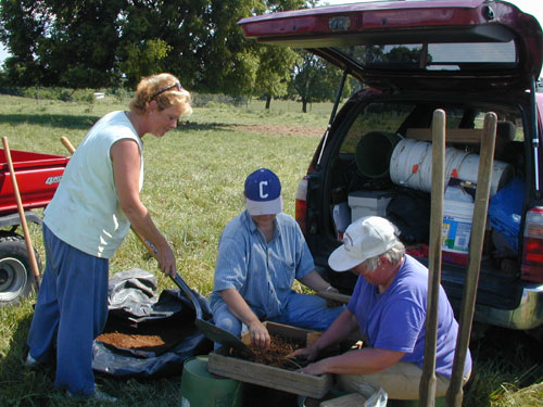 Donna Kinser, Jeanne Burke, and Cheryl Munson screened the stockpile of excavated soil from the hole to collect artifacts