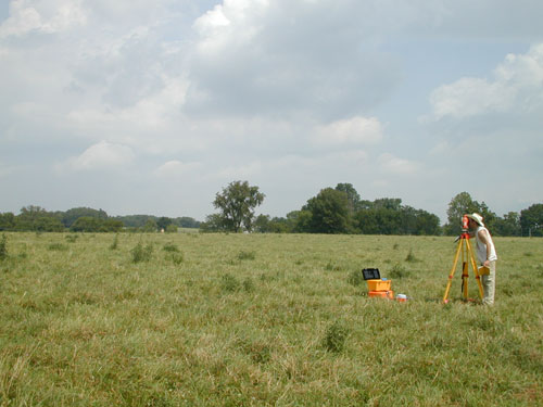 Andy White and Glenn Perry Harrell use the total station to collect data for detailed topographic mapping.