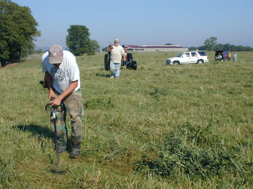 Mike Strezewski mows the tall grass to facilitate collection of augured soil.